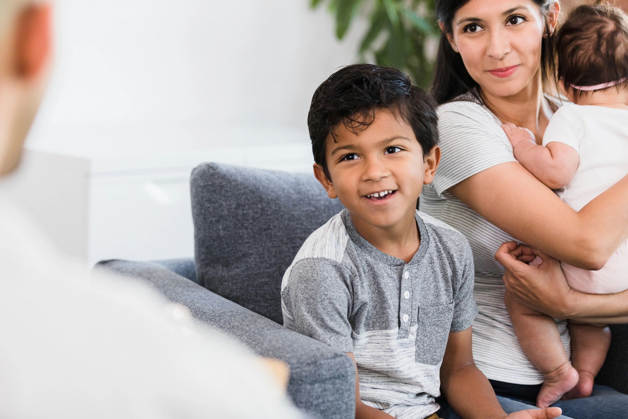 Parent meeting with a support worker while caring for young children