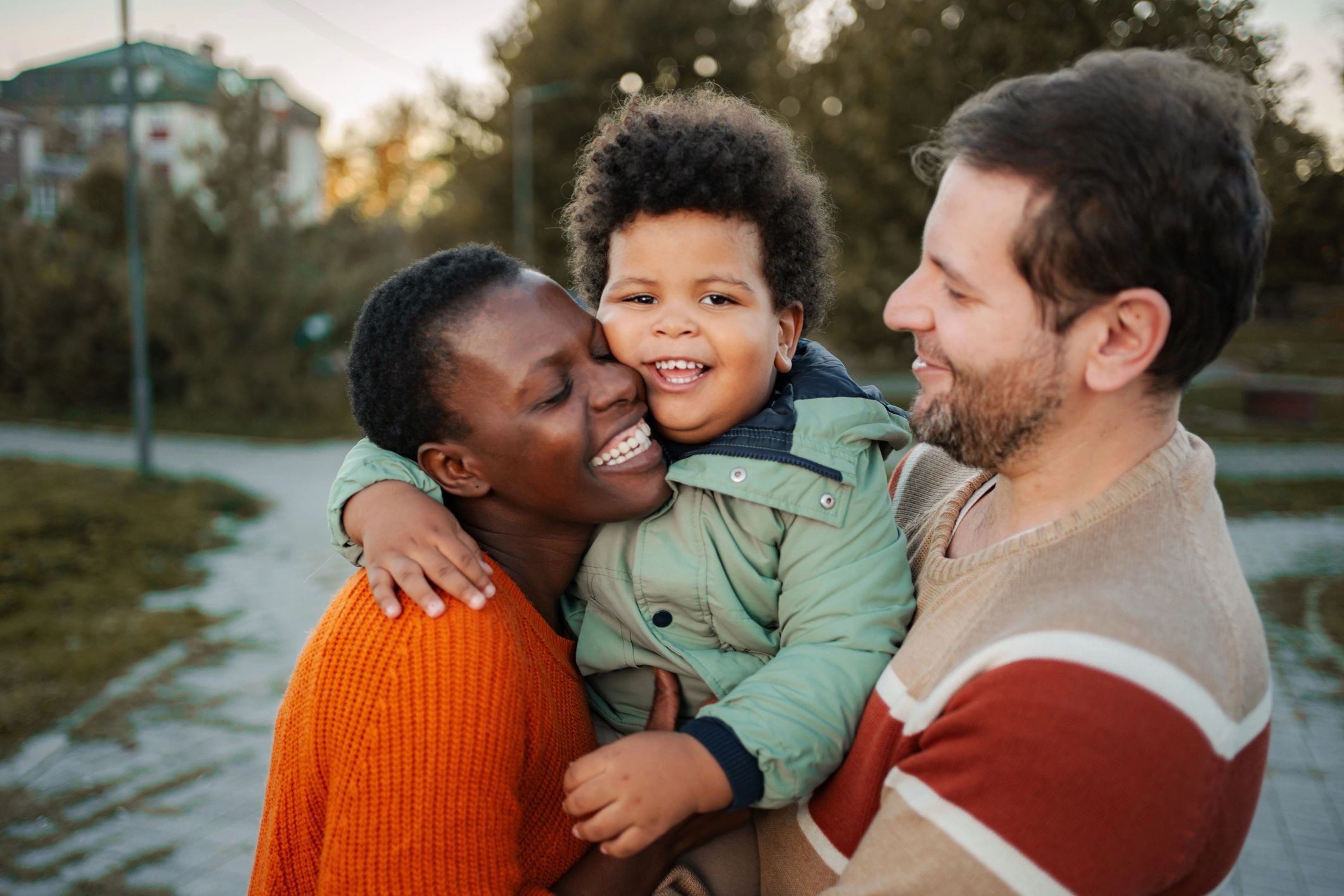 Family sharing a warm supportive moment outdoors